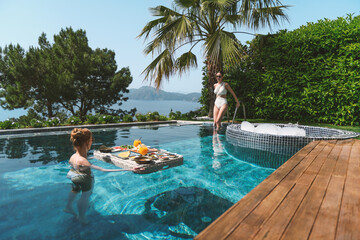Friends Enjoying Floating Breakfast in Private Pool