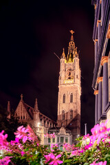 Tower of the St Baaf's Cathedral in the illuminated city center of the Flemish city of Ghent