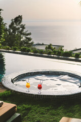 Fototapeta premium Colorful Cocktails by Bubble Jacuzzi in Poolside Hotel Room