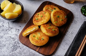 Potato cakes with cheese filling on a wood cutboard