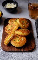 Potato cakes with cheese filling on a wood cutboard