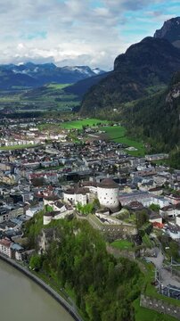 Aerial around view of Kufstein town with medieval Castle fortress in Tyrol, Austria, Alps mountains. Vertical video