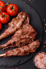 Juicy meat on the bone or rack of lamb. Grilled veal with salt, spices and herbs