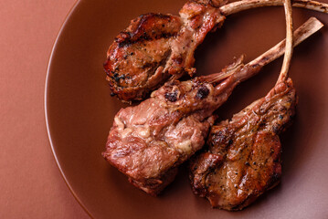 Juicy meat on the bone or rack of lamb. Grilled veal with salt, spices and herbs