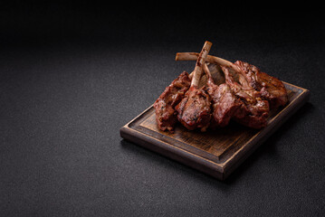 Juicy meat on the bone or rack of lamb. Grilled veal with salt, spices and herbs