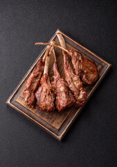 Juicy meat on the bone or rack of lamb. Grilled veal with salt, spices and herbs