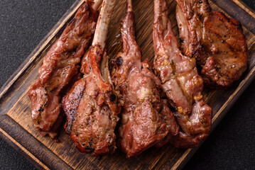 Juicy meat on the bone or rack of lamb. Grilled veal with salt, spices and herbs