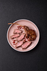 Juicy meat on the bone or rack of lamb. Grilled veal with salt, spices and herbs