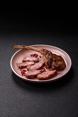 Juicy meat on the bone or rack of lamb. Grilled veal with salt, spices and herbs