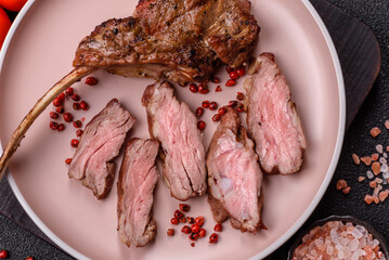 Juicy meat on the bone or rack of lamb. Grilled veal with salt, spices and herbs
