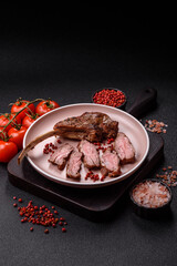 Juicy meat on the bone or rack of lamb. Grilled veal with salt, spices and herbs
