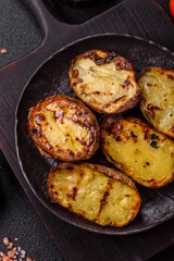 Food, potatoes cut in halves or slices grilled. Cooked baked potatoes
