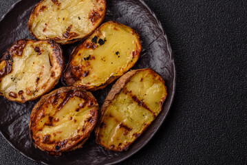 Food, potatoes cut in halves or slices grilled. Cooked baked potatoes