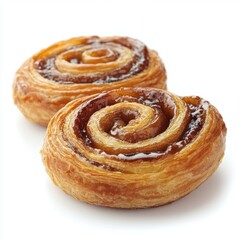 Fototapeta premium Freshly baked sweet cinnamon rolls with glossy caramel glaze on flaky pastry layers and spiraled shape, close-up view highlighting texture and golden color