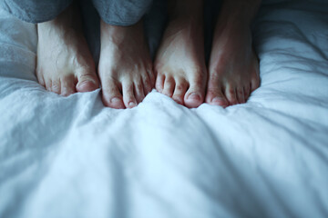 a couple of feet that are on a bed
