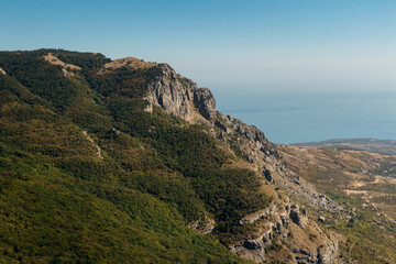 Panoramic view from mountain top towards valley and sea