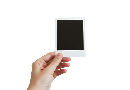 A hand holds a polaroid blank picture, isolated on white or transparent background. PNG