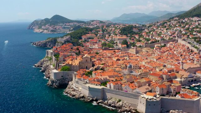 Establishing aerial shot of historic Dubrovnik in Croatia. Iconic old town, medieval walls, and breathtaking coastline. Beauty of the Adriatic Sea and landmark architecture. 4K drone panorama