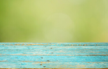 Empty Wooden table and blurred green nature background. Free copy space. Narrow depth of field.