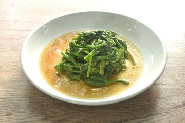 fried Chayote sprout with chili and soybean sauce on plate