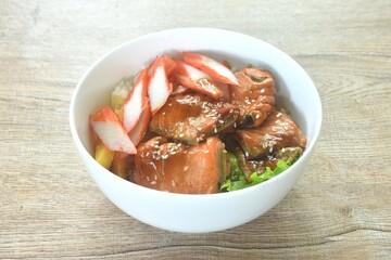 grilled saba fish or mackerel topping crab stick and lettuce on japanese rice in bowl