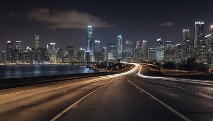 An empty road leads to the city skyline at night 