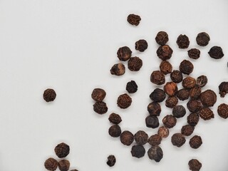 Black pepper grains for seasoning, food ingredient isolated on white.