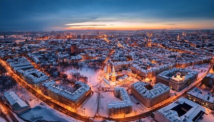 Fototapeta premium drone captures urban charm in a snowy city landscape at twilight