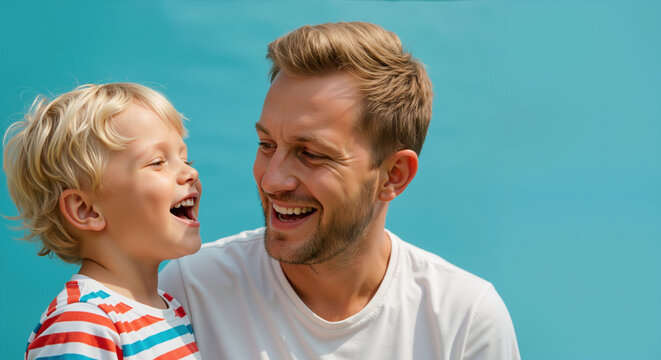 Father and son sharing genuine laughter against turquoise background with matching expressions. Father's day joyful moment capturing authentic connection and emotional bonding