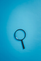 Magnifying Glass On Vibrant Blue Minimalist Image Shot For Marketing With Exceptional Clarity, Enhancing Focus On Composition And Glass Detail Against Clean Background