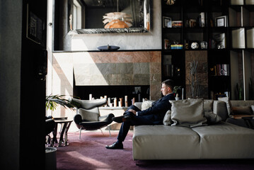 portrait of groom in blue tuxedo in hotel