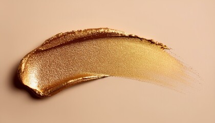 Golden shimmering highlighter texture on beige background