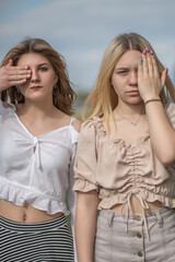 Portrait of two beautiful young girls friends in an urban environment.