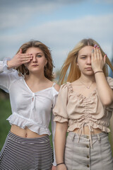 Portrait of two beautiful young girls friends in an urban environment.