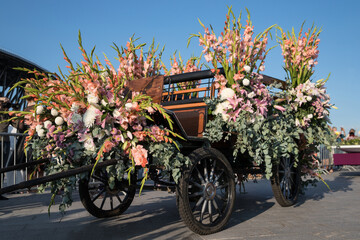 A carriage decorated with flowers. The annual International Flower Festival in St. Petersburg