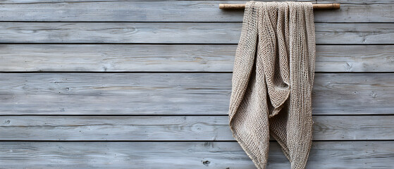 Beige Patterned Blanket Hanging On Gray Wooden Wall