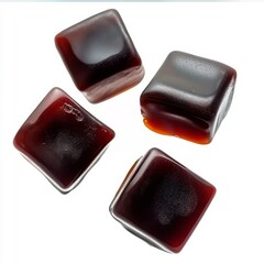 Levitating brown gummy cubes with splashing liquid, floating against a clean studio backdrop.

