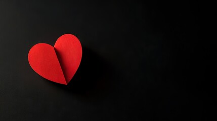 Fototapeta premium Red heart on black, soft gradient light, minimalist design. Symbol of love and simplicity in a bold visual statement. 