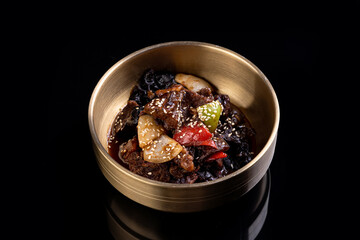 Vibrant dish showcases a medley of textures and colors featuring tender meat, fresh vegetables, and...