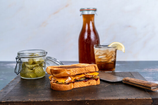 BBQ chicken sandwich with pickles and iced tea