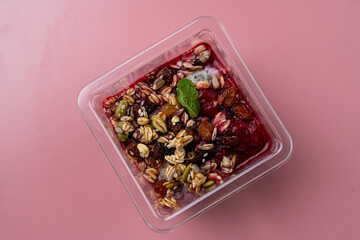 A vibrant dessert combines juicy fruit and crunchy nuts in a stylish dish. Bright colors and...