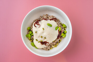 Savor the delightful combination of earthy buckwheat and luscious sauce, adorned with bright green edamame, creating a nourishing and vibrant meal served in a stylish bowl