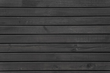 Black wooden planks arranged in horizontal rows. Abstract vintage background.