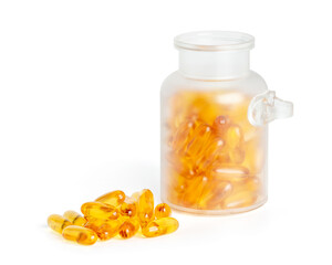 Frosted glass jar packaging with fish oil capsules and some pills outside on white background