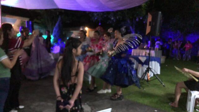 Defocused and blurry video footage of an evening party following a street pageantry parade.
