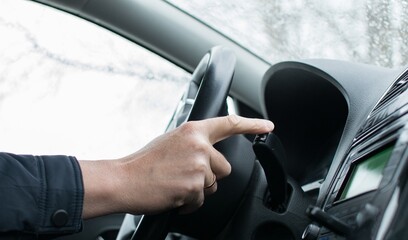 The driver's finger presses the mode control key of the route computer