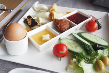 top view of turkish breakfast with Fresh vegetables, egg, and dips
