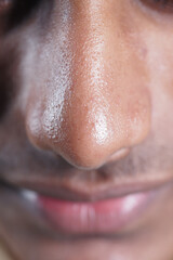 Close-up view of a man's nose and lips during daytime