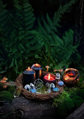 witch copper cauldron, burning black candles, amulet, quartz crystals in forest, nature background. occult esoteric spiritual practice. wiccan magic ritual, witchcraft. fairytale, mystery atmosphere
