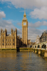 Fototapeta premium A dramatic low-angle shot captures the grandeur of Westminster Bridge and the towering Big Ben, emphasizing their architectural magnificence against the London skyline